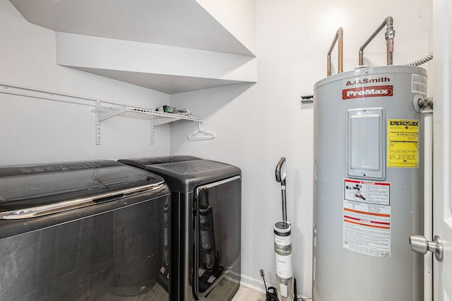 laundry area with water heater, laundry area, separate washer and dryer, and baseboards