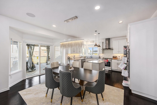 dining room with recessed lighting, dark wood-style flooring, and baseboards