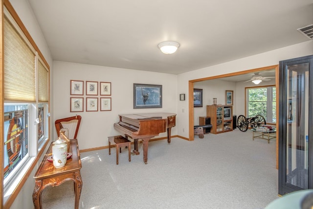 sitting room with baseboards, visible vents, and carpet flooring