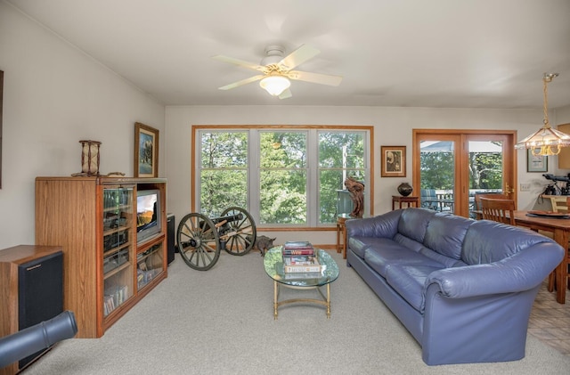 carpeted living room with a ceiling fan and french doors