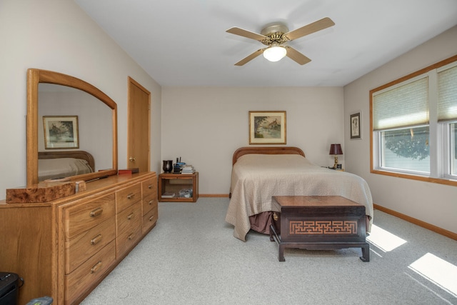 bedroom featuring baseboards, ceiling fan, and light colored carpet