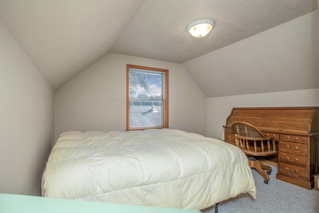 bedroom with vaulted ceiling and carpet flooring