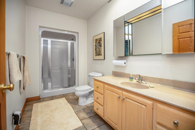 bathroom with toilet, a stall shower, tile patterned flooring, and vanity