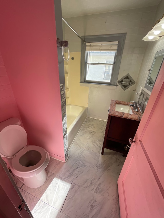 full bathroom featuring marble finish floor, vanity, toilet, and bathing tub / shower combination