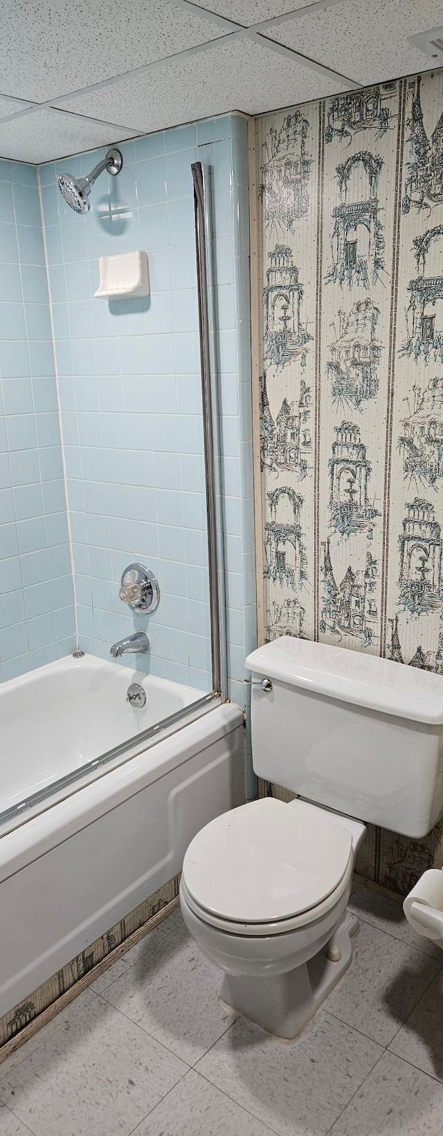 bathroom featuring toilet, shower / tub combination, and tile patterned floors