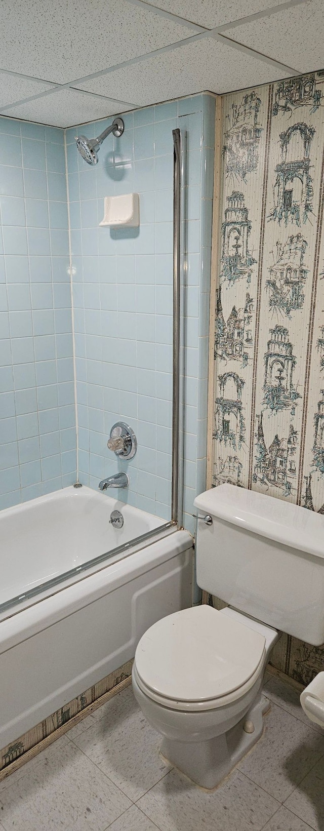 bathroom with shower / bath combination, toilet, and tile patterned floors