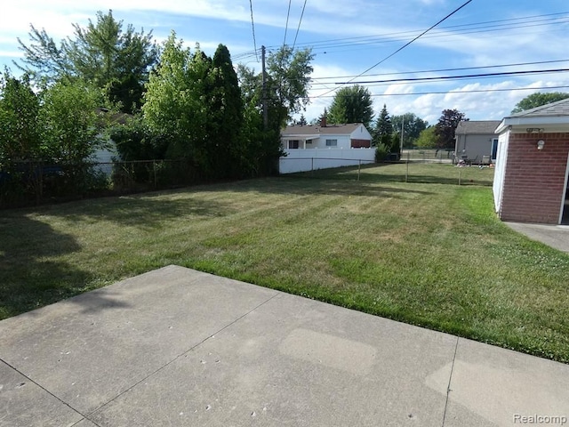 view of yard with fence and a patio