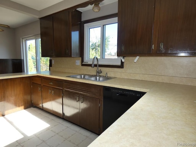 kitchen featuring light countertops, a sink, dishwasher, and dark brown cabinets