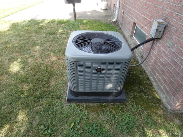 exterior details featuring central air condition unit and brick siding