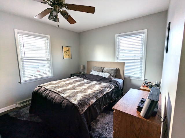 bedroom with a ceiling fan, visible vents, and baseboards