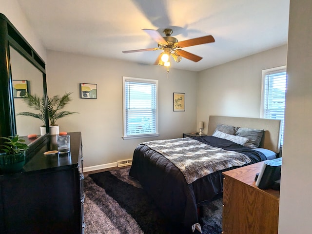 bedroom with a ceiling fan, visible vents, and baseboards