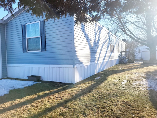 view of side of home with a lawn