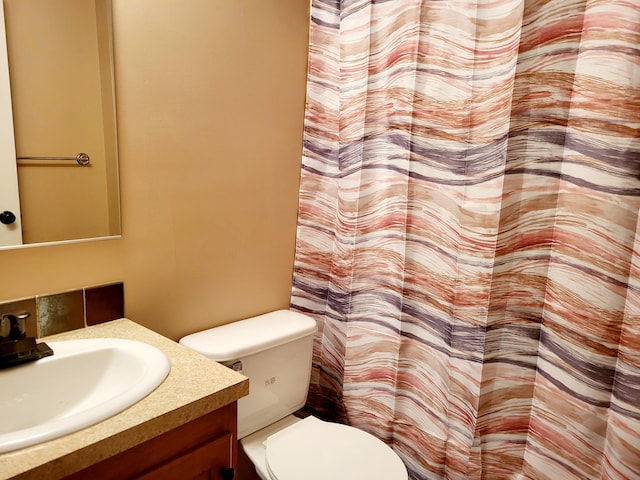 full bathroom with toilet and vanity