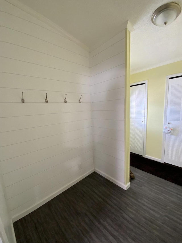 mudroom featuring baseboards, dark wood-style flooring, and crown molding