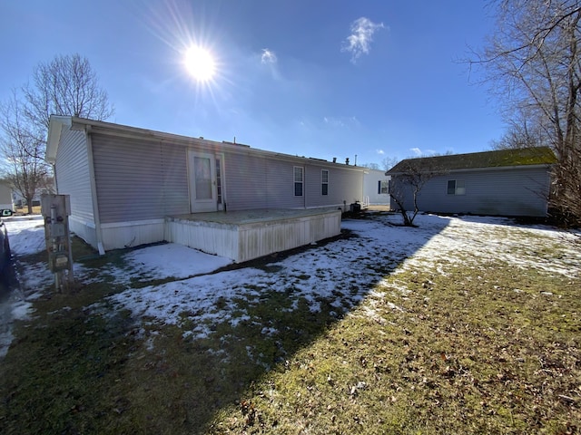 view of snow covered back of property