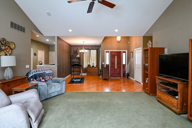 living area with recessed lighting, visible vents, carpet floors, high vaulted ceiling, and ceiling fan with notable chandelier