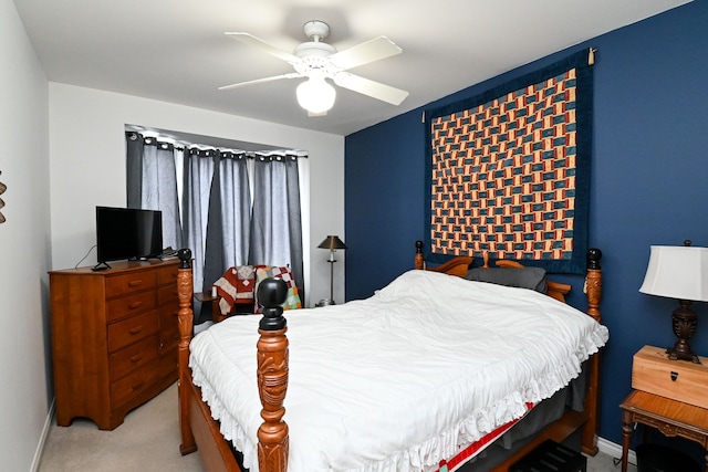 bedroom with light carpet, a ceiling fan, and baseboards