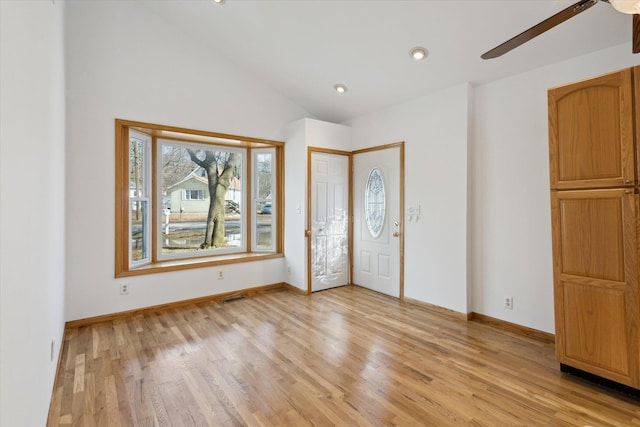 foyer entrance featuring lofted ceiling, baseboards, light wood finished floors, and recessed lighting