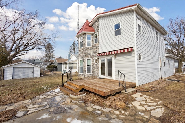 rear view of property with stone siding and a deck