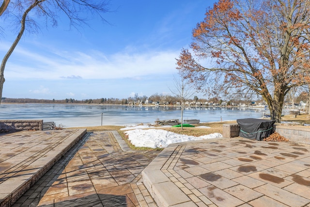 view of patio with a water view