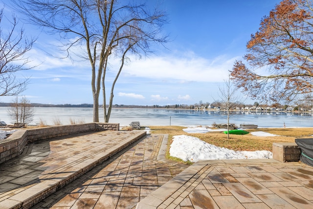 exterior space with a water view and a patio