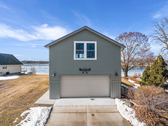 garage featuring a water view and concrete driveway