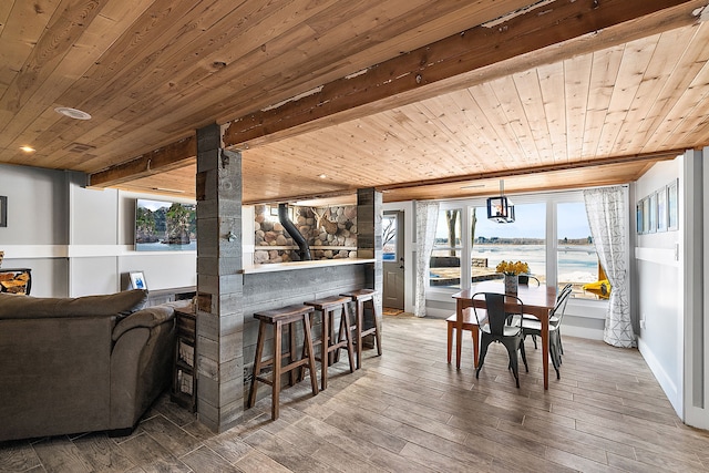 dining room with plenty of natural light, a water view, and hardwood / wood-style flooring