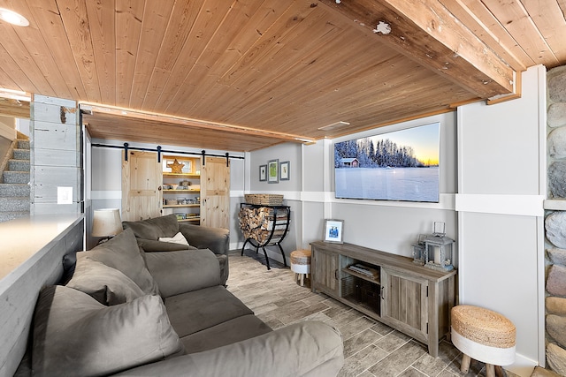 living area with a barn door, wood ceiling, light wood-style floors, stairway, and beam ceiling