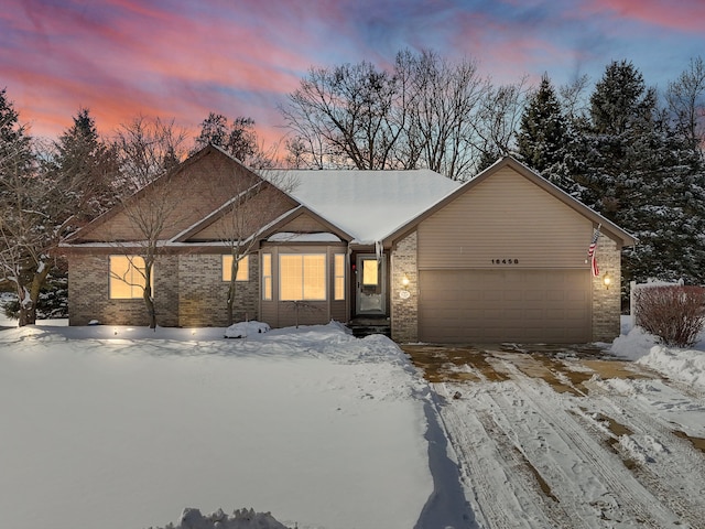 view of front of property featuring a garage and brick siding