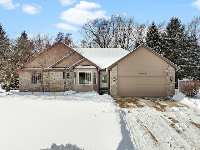 view of front facade with an attached garage and brick siding