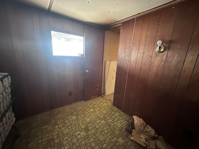 hallway featuring wooden walls