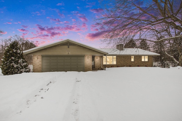 single story home with brick siding and an attached garage