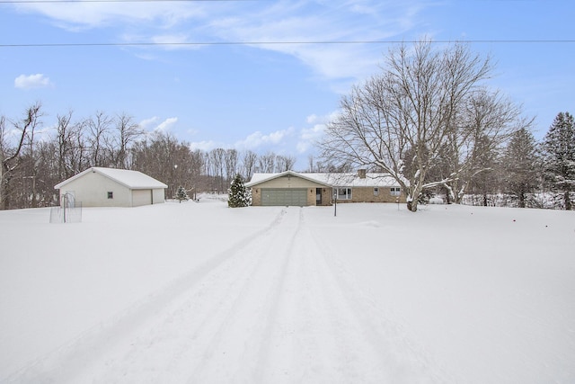 yard covered in snow featuring a garage