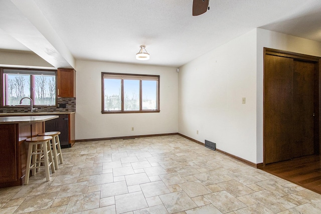 interior space with a healthy amount of sunlight, visible vents, and baseboards