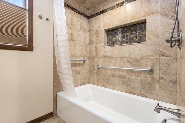 bathroom with shower / bath combo with shower curtain and baseboards