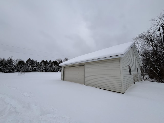 snow covered garage with a garage