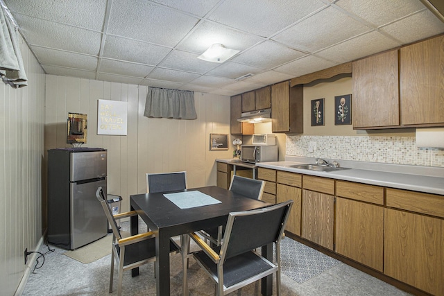 dining area featuring a paneled ceiling