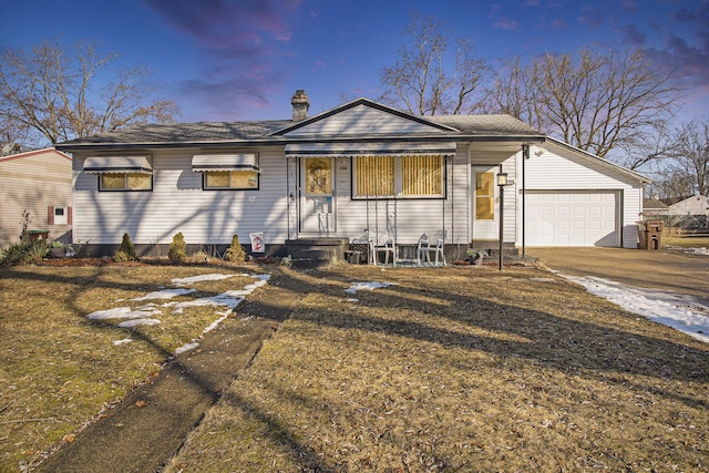 ranch-style house featuring a garage, entry steps, concrete driveway, a chimney, and a front lawn