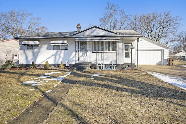 view of front of home featuring a chimney, concrete driveway, a front yard, entry steps, and a garage