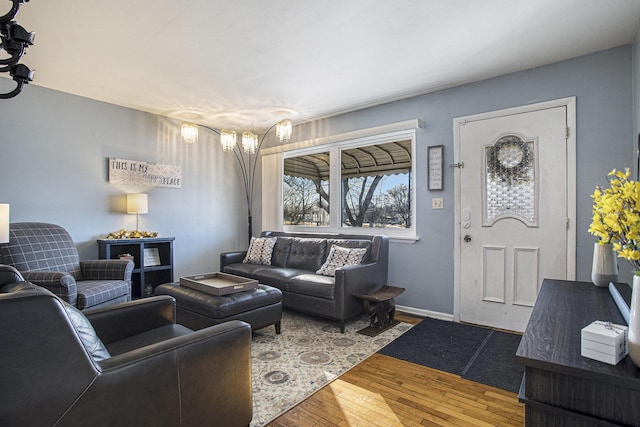 living area with baseboards and hardwood / wood-style floors