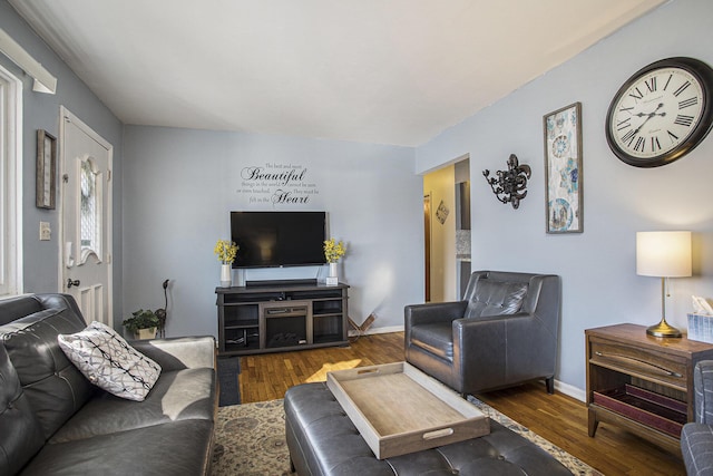 living room with baseboards and wood finished floors