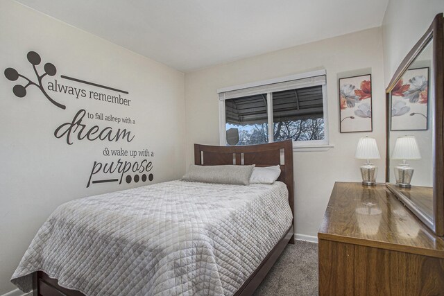 bedroom featuring carpet floors and baseboards