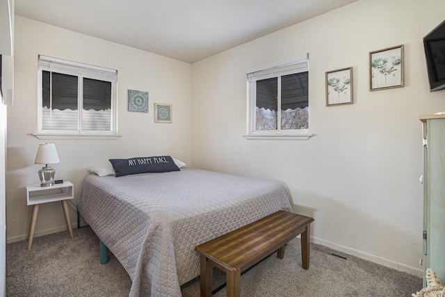 carpeted bedroom featuring visible vents and baseboards