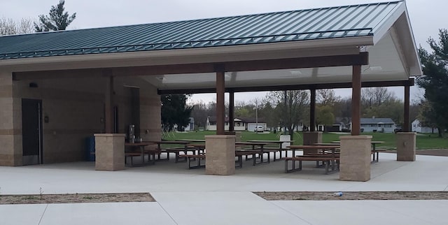 view of community featuring a lawn, a patio, and a gazebo