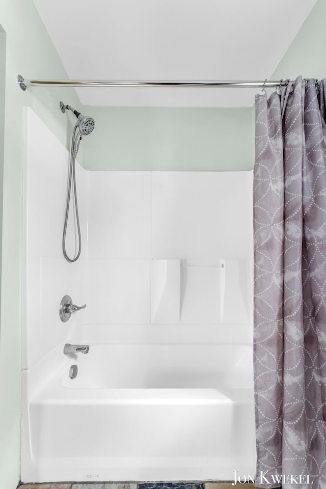 bathroom with shower / bathtub combination with curtain