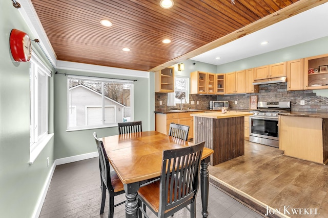 dining room featuring a healthy amount of sunlight, light wood-style flooring, wood ceiling, and baseboards