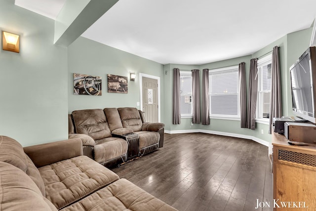 living area featuring baseboards and dark wood-style flooring