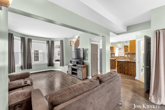 living area with hardwood / wood-style floors and baseboards