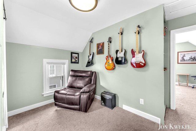 sitting room with carpet, baseboards, and vaulted ceiling