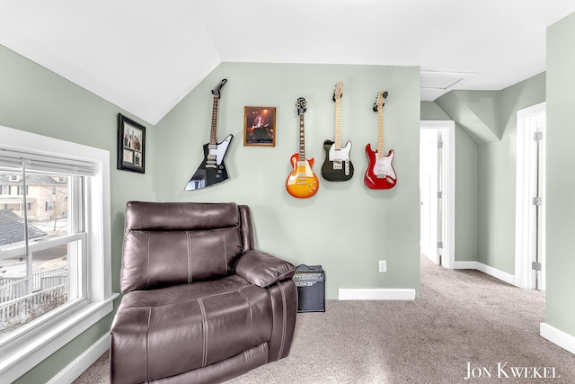 living area with carpet, baseboards, and vaulted ceiling